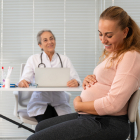 The Pregnant Woman Lovingly Cares For Her Baby In Her Doctor's Office