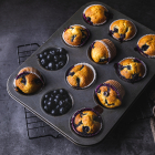 Homemade blueberry muffins in baking mold .